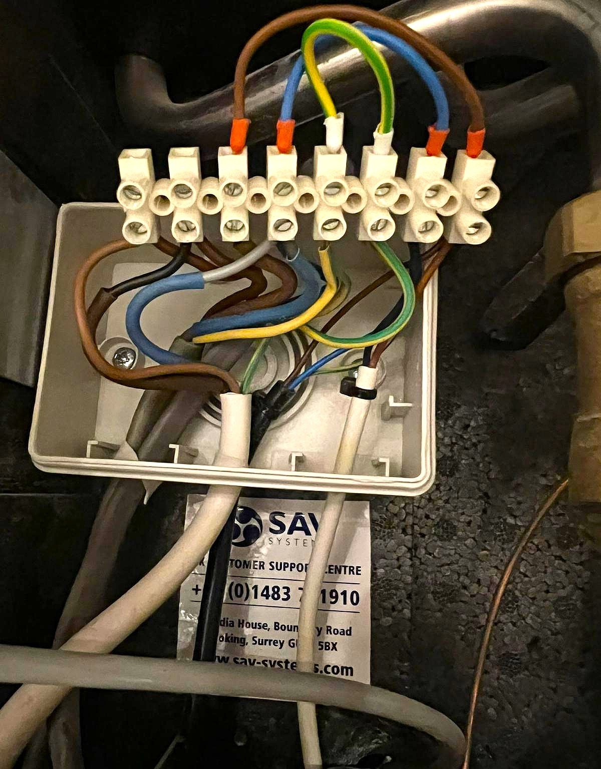 Electrical wiring terminals inside Heat Interface Unit during repair in London