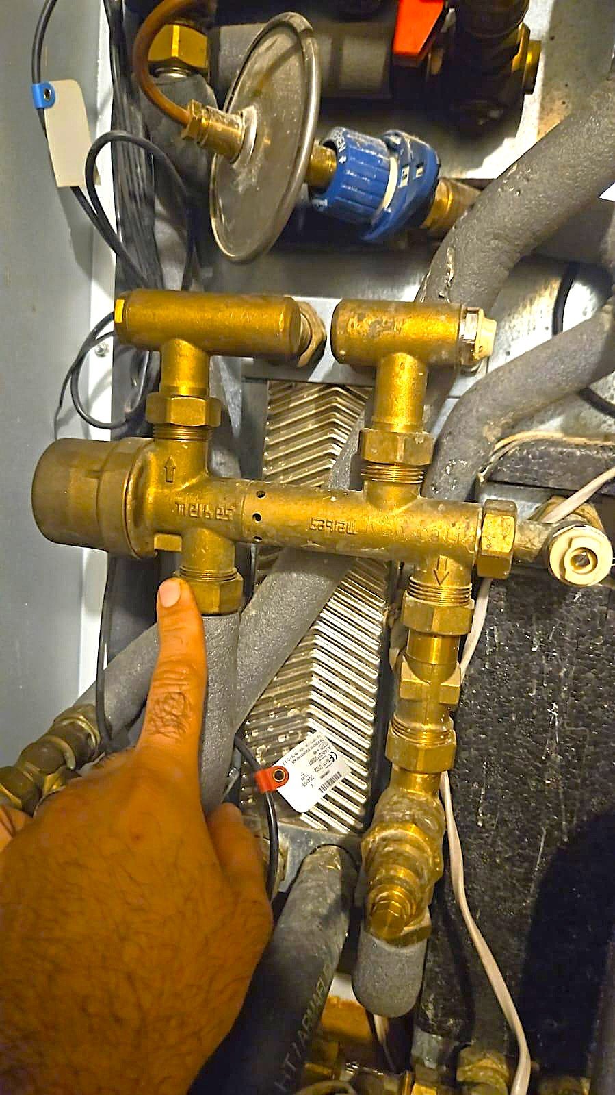 Heat exchanger pipework inside HIU unit during servicing work in London property