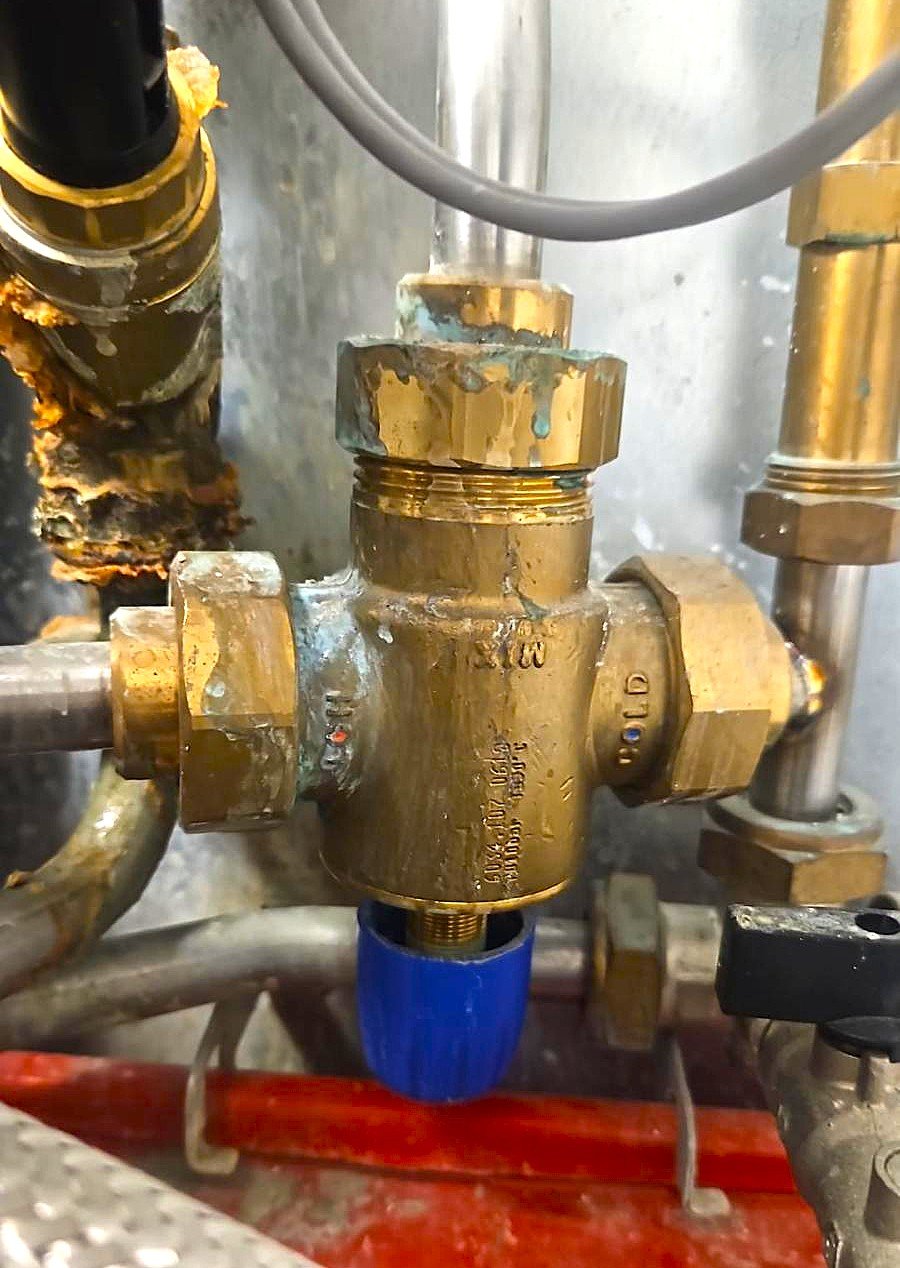Mixing Blending valve connection on HIU heating system during repair in London